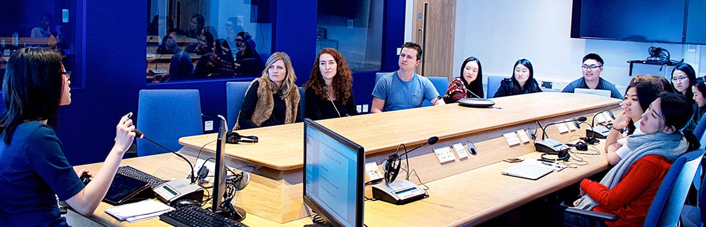 Group of people in room at a desk