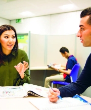 Two students talking and studying.